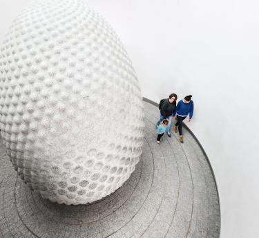 Family walking around a big sculpture at Eden Project